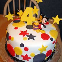 Mickey Mouse Very quick for a friend at work. Choc Fudge cake w/ buttercream. Covered in fondant with fondant accents. Mickey is a candle. TFL