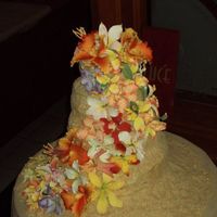 Flowers On The Beach Luau themed Graduation party cake, gum paste flowers on a 4 tier sand covered cake