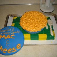 Mac And Cheese 3 fondant covered cake, the Mac is piped butter cream an the utensils are gumpaste