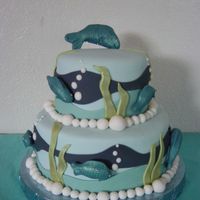 Fish Birthday Cake 9" and 6" vanilla bean cake filled with bavarian cream and strawberries. Covered and decorated in fondant. All the fish were hand...