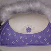 Purple Purse Cake Birthday cake for niece. Vanilla bean cake with vanilla BC filling and MMF. Base is chocolate cake with vanilla BC. Handle is boa with wire...