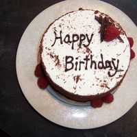 Generic Birthday Cake chocolate cake topped with whipped cream, filled with whipped cream and raspberry jam.