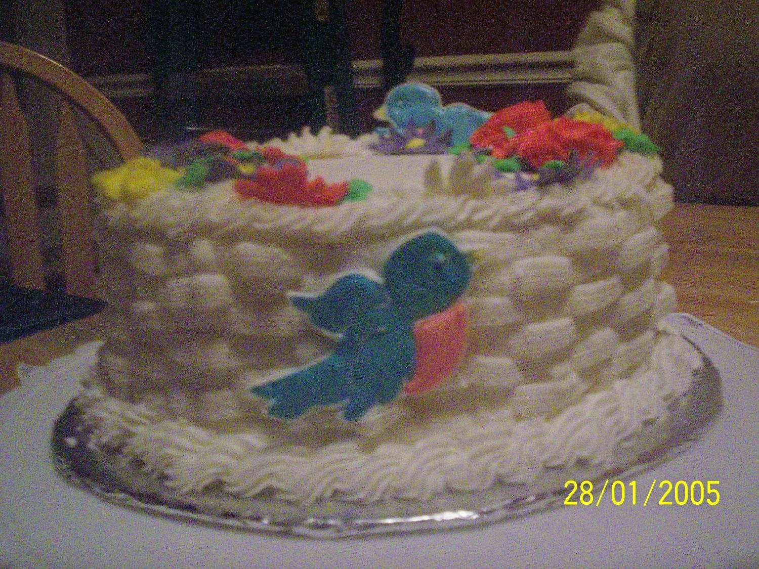 Wilton_Class_Cake.jpg this is my first attempt at basket weave. I had to cover most of my mistakes with the bird. The flowers are getting easier the more I try...
