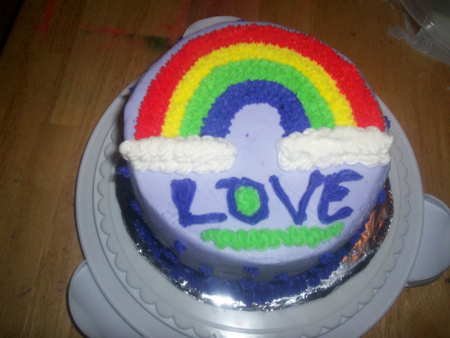 First_Cake.jpg this was the cake i made in my first class. we were learning stars and small flowers. i've gotten a little better since then. lol.