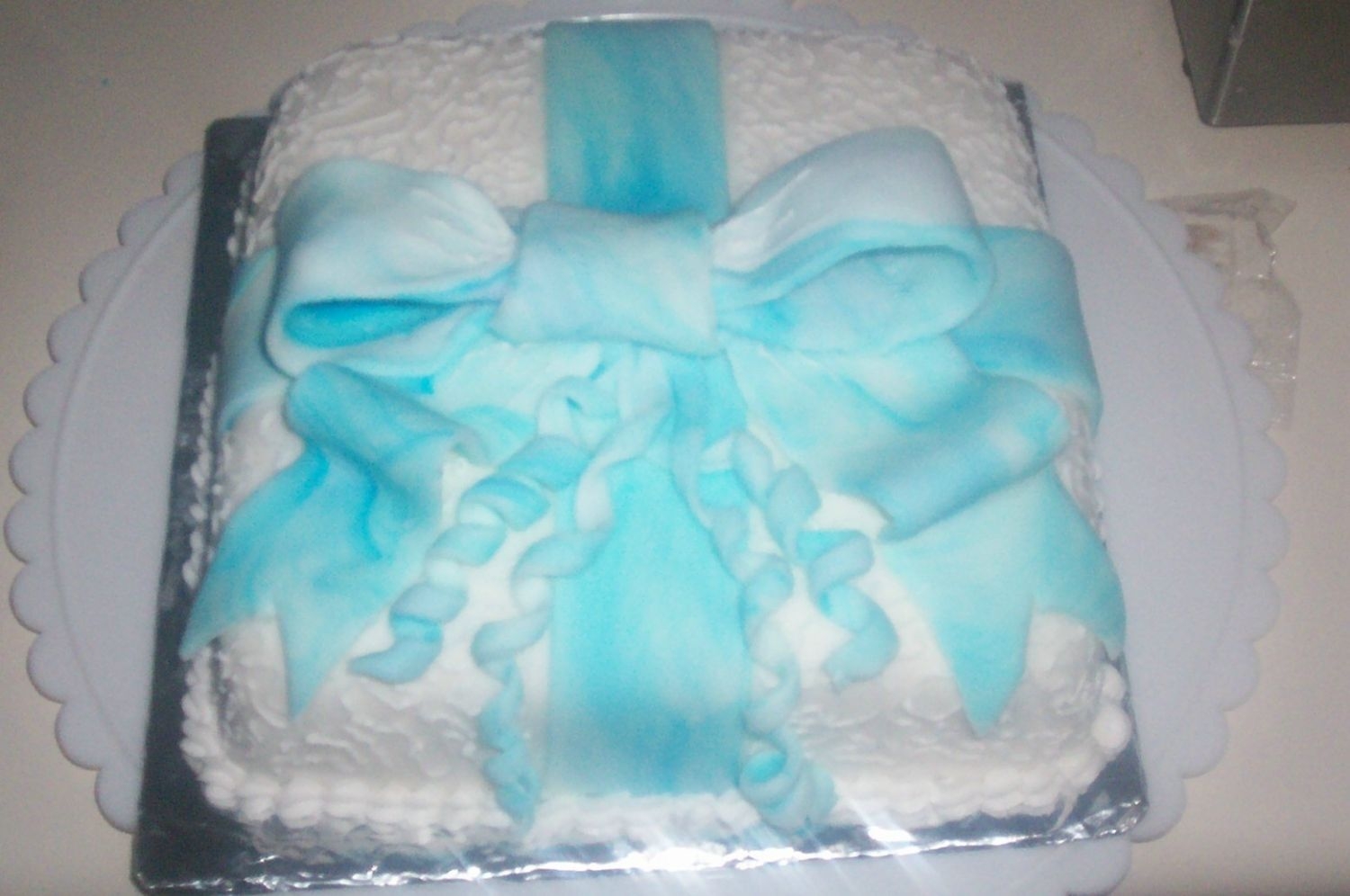 Wilton Course Iii Gift Package Cake I made this in my class. I used fondant that I marbelized with blue and then added cornelli lace. I'm pleased since it was the first...
