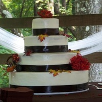 Autumn Wedding Cake This was my cousin's wedding cake. White cake with buttercream filling and frosting, with fake fall flower accents. i was new to cake...