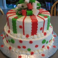 Christmas Cake With Gumpaste Bow This cake is made of a 10" and 12" round, filled with strawberry. Buttercream icing with MMF decorations. My very first gumpaste...