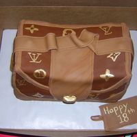 Lv 18Th Birthday Cake 9x13 cake cut in thirds covered with buttercream with caramel filling and fondant over the top with fondant accent pieces. Hand painted...