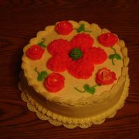 Wilton Cake Course I This is a yellow cake filled with buttercream icing. I piped buttercream roses & used piping gel to outline the large flower in the...