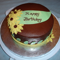 Yellow Daisy Birthday Cake Chocolate buttercream with fondant accents.