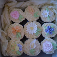 Flower Cupcakes Chocolate & carrot cupcakes with vanilla buttercream. Assorted flowers are a mixture of royal icing and gumpaste.