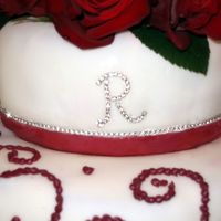 Top Tier Of Rachie's Red Rose Cake Well, her name is Rachael, hence the rhinestone "R"The rhinestones are not edible, you can buy them by the yard at the craft...