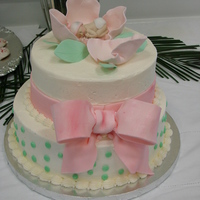 Shower Cake Almond Cake and Chocolate Cake ........ Buttercream Icing .... Gumpaste Flower, Baby and Bow and Fondant Ribbon.