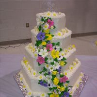 He Loves Me...she Loves Me Iced with French Buttercream Icing and all the flowers I made of Royal Icing. The Bride chose a clear topper that had daisies and the words...