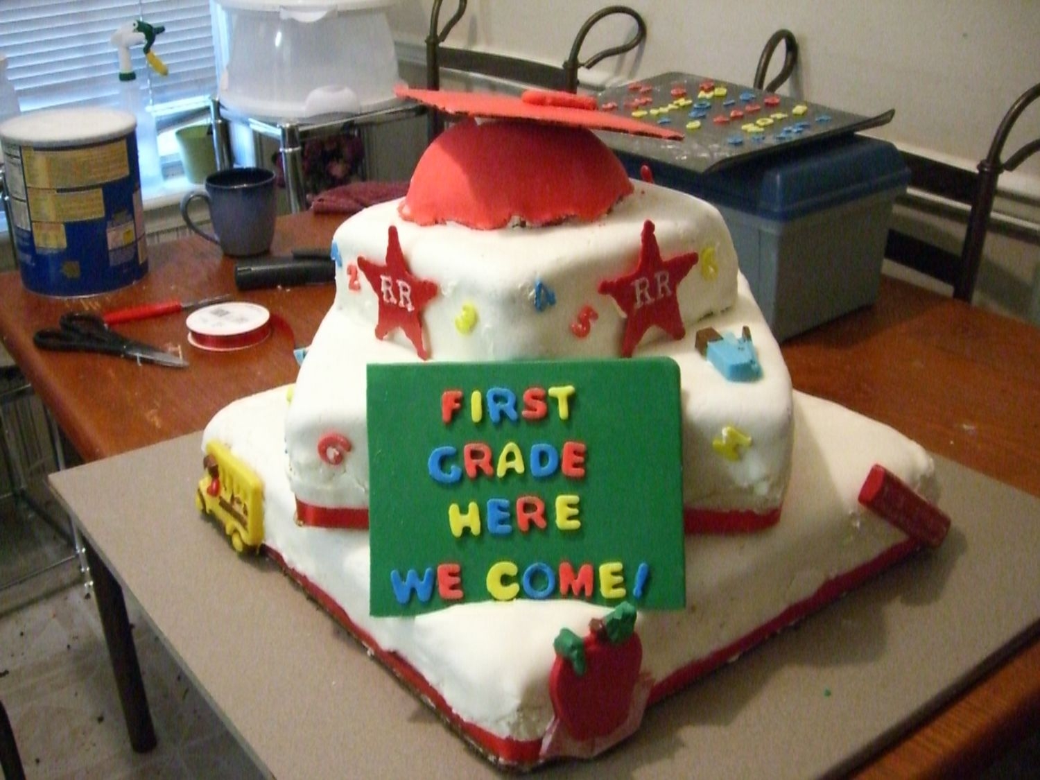 Kindergarten Graduation This cake was made for my daughter's kindergarten graduation; three tiers, MMF+RBC, chocolate decorations, and the graduation cap on...