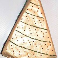 Golden Christmas Tree White chocolate raspberry cheesecake on chocolate crust. Wrapped in pure white chocolate with old gold luster dust, bc decorations.