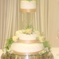 Wedding Cake Held Up By Champagne Flutes 
