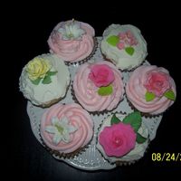 Cup Cakes! First try at decorated cupcakes. Wow, much easier than decorating a cake! 100% butter BC icing, gumpaste and royal flowers and leaves. I...