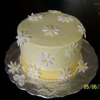 Daisy Cake Inspired By Boween! French vanilla cake with chocolate pudding center, Buttercream with fondant accents. My first try with fondant. The bow was a wreck, so I...