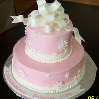 First Tiered Cake, Graduation Buttercream with fondant acents and bow. Luster dust and sparkels too (on the bow and daisies), you cannot see them in the photo. Sorry...