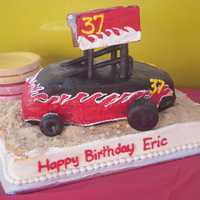 Sprinit Car The base of the cake is a 9x13 with vanilla wafers on it. The car is carved and covered in MMF.