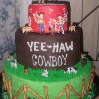 Woody Cowboy Cake 3-double layers- bottom layer green, middle layer chocolate and top layer yellow all buttercream,. the figures were provided by the gramma...