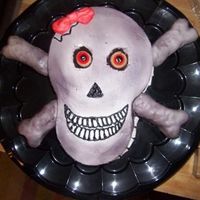 Cute Skully RED velvet cake with rice crispy cross bones covered in fondant and the cake was buttercream...the eyes I purchased from Walmart they are...