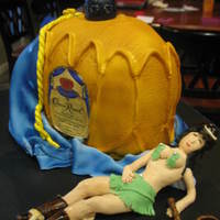 Crown Royal Cowgirl crown royal bottle cake, cake is yellow with crown royal custard filling, and gumpaste cowgirl passed out