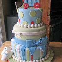 Train Baby Shower This cake was designed to match the baby's bedding. Covered in MMF, bows and baby shoes made from 50/50 fondant/gumpaste. Thanks for...