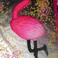 Pink Flamingo For a flamingo lover. Cake was almost 3 foot long. The body is white cake and the legs, head and neck are rice crispy treats...all covered...