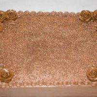 Chocolate Cake Chocolate cake with chocolate whipped buttercream and tootsie roll roses with grated chocolate on top.