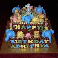 Animal Cake All animals made with fondant. The fence is chocolate sticks. The cake is butter cake with buttercream icing.