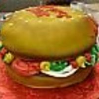 Hamburger Made from a 9" round cake with fondant covered bun and patty. Toppings/ Fixins are done in Butter Cream