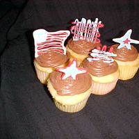 Memorial Day Cupcakes White cupcakes with chocolate icing and chocolate decorations on top.