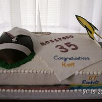 From High School To College. Double layer full sheet iced in buttercream with fondant covered football cake and fondant jersery deplicting graduation from HS. Gumpaste...