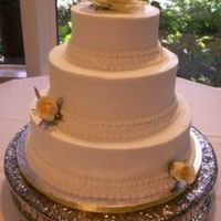 Brandywine I 3 tier buttercream with hand piped lace and yellow silk roses.