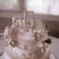 Danielle Ii Close-Up Of Top Tier close-up of top tier with monagrams and gumpaste flowers