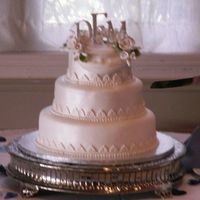 Danielle Ii 3 tier fondant with monagrams and gumpaste flowers.