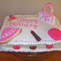 Girl- Y Cake Buttercream frosting with two 9x13 cakes; chocolate/candy lipstick and make up with hat and purse cookies (roayal icing)