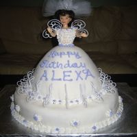 New1_006.jpg This is Birthday cake I was asked to make for a 5 year old. I have no idea why the mother requested the doll with a wedding veil but ..hey...