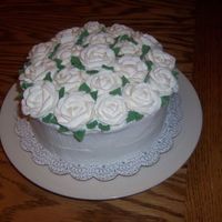 Flowers For Mom This is a 8 inch round cake with Butter cream and royal icing roses. The roses for some reason colapsed a bid, I think it was the...