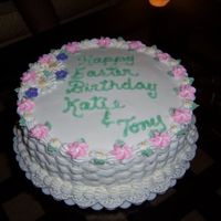 Newcake06_003.jpg This is a 10 inch cake Covered with butter creeam icing and the flowers are make with royal icing. I chose the weaving for the sides.