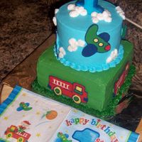 Fire Engine And Airplane Cake First time doing chocolate transfers. I was pleased with how the fire engine and airplanes turned out. REst is butter cream. Done to match...