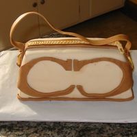 Coach Bag My first attempt at a purse cake. A bit messy in spots, but the zipper was my first attempt at gum paste, so I was content.