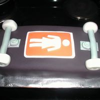 Skateboard Cake I cut a sheet pan in the shape of a skateboard and covered it with butter cream & fondant.