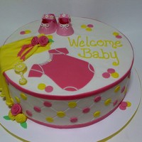 Pink And Yellow Baby Shower 12 Inch cake Buttercream with fondant details. The booties were 50/50 gumpaste and fondant. My first time doing the diamond pattern, and by...