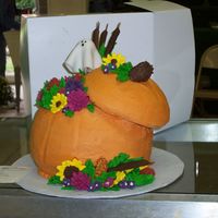 Pumpkin Vase Inspired Cake Pumkin is made out of 3, 8 inch layers with 6 inch lid shaved to give better shape. Flowers, indian corn and cattails are made from royal...
