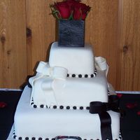 Square Wedding Cake This is my first wedding cake. top and bottom is yellow cake, middle is chocolate covered in mmf Black bows are cinnamon mmf and the white...