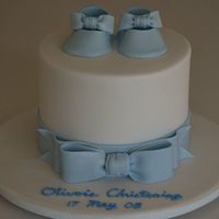 Oliver's Christening Cake Double stacked 6 inch chocolate mud cakes. Baby booties and big bow are made of modeling fondant.