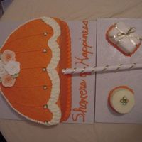 Umbrella_Cake.jpg This was another joint effort. I frosted and decorated the umbrella and my partner did all of the small cakes on the board. We weren't...